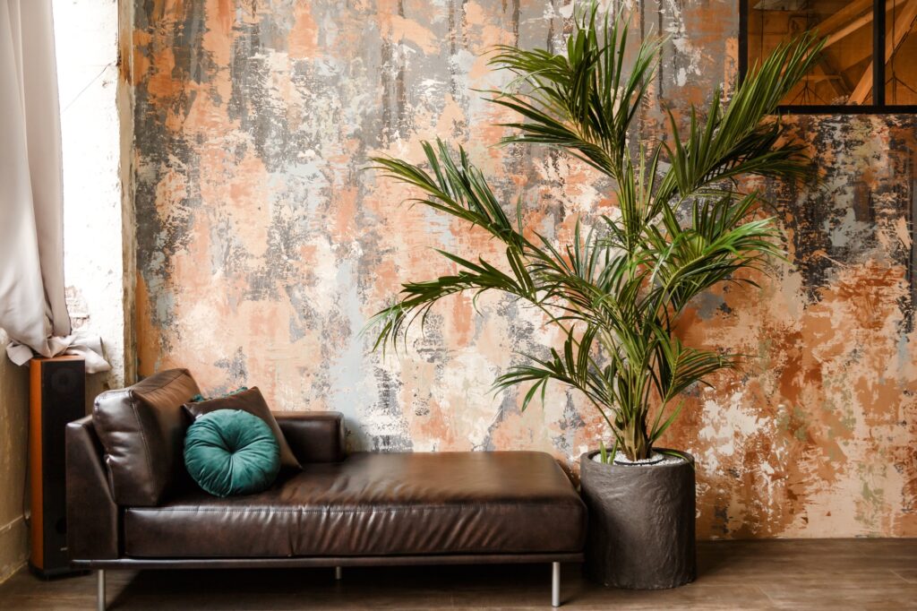 Modern leather couch and big houseplant in loft room