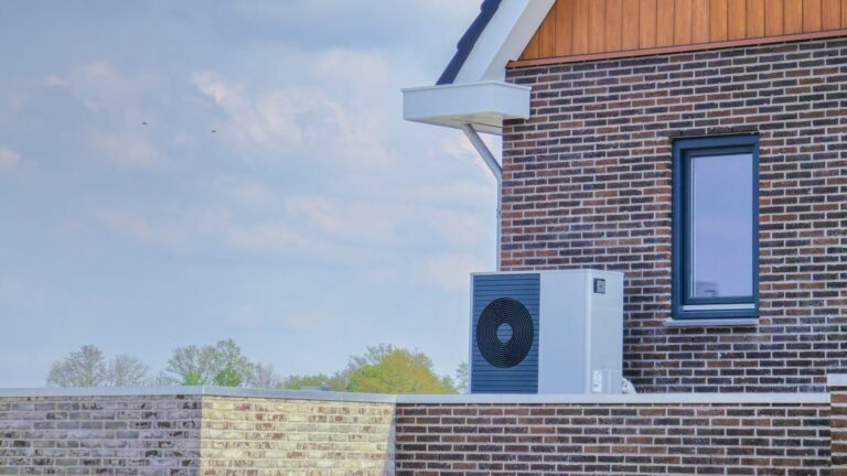 air source heat pump unit installed outdoors at a modern home with bricks in the Netherlands