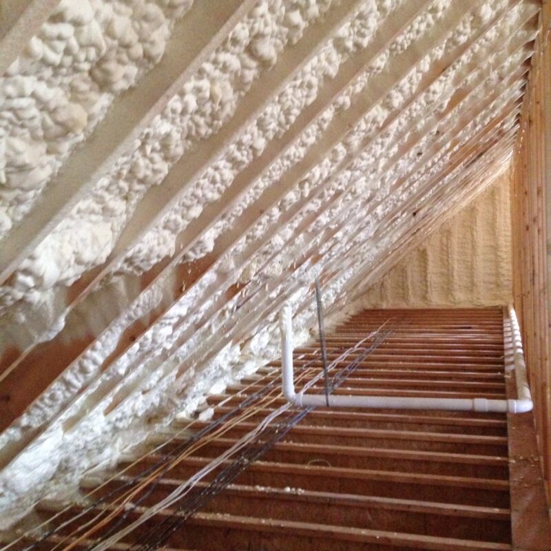 New house or home attic rafters with spray insulation for energy conservation