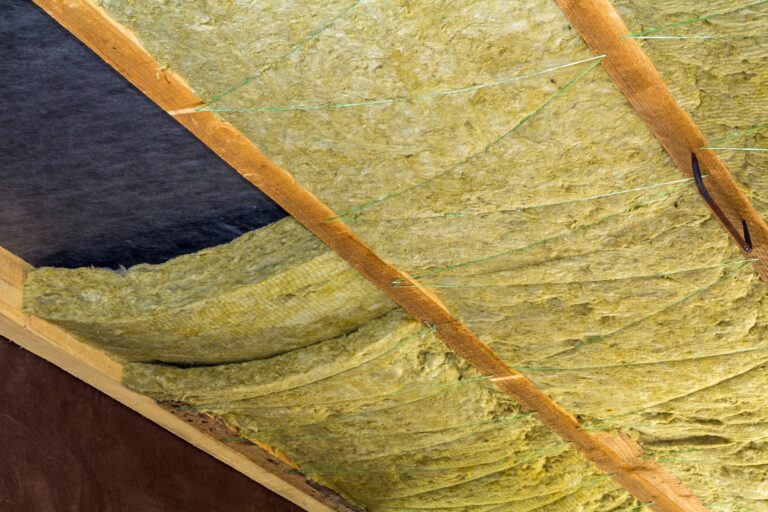 Thermal insulation mineral rock wool installation at the new building attic ceiling