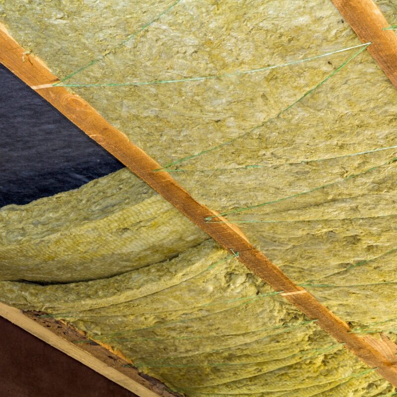 Thermal insulation mineral rock wool installation at the new building attic ceiling