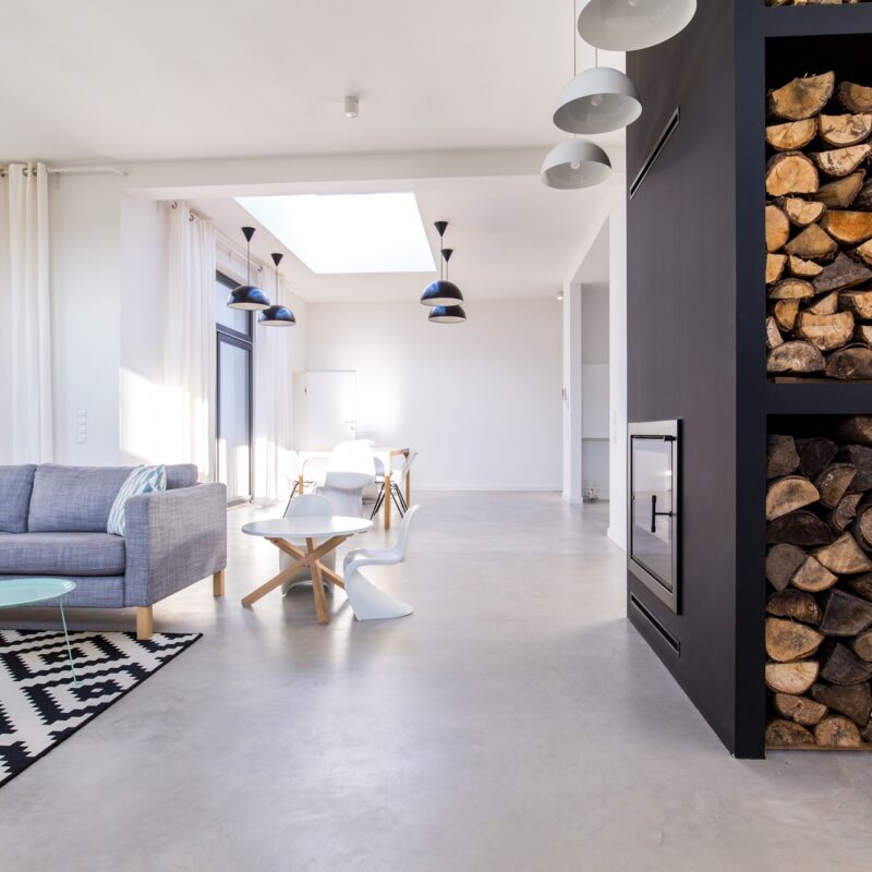 White living room in modern minimalist house with concrete floor