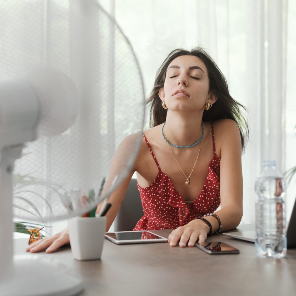 Woman cooling herself at home