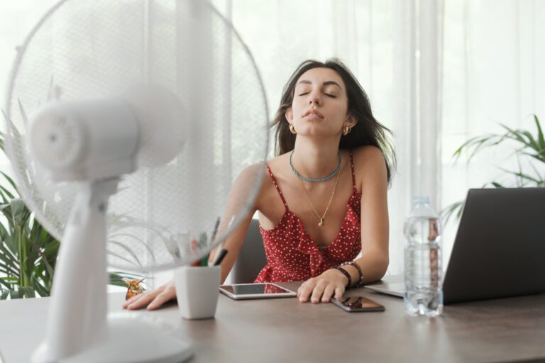 Woman cooling herself at home